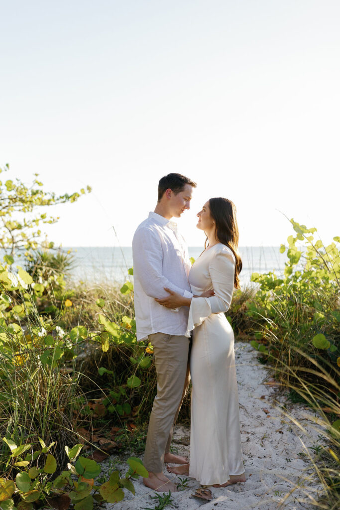 couple gazing at each other during their engagement photos on the beach in Naples Florida
