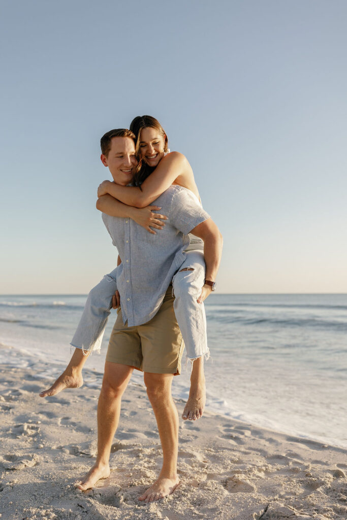 Romantic embrace in casual engagement photo outfits beach style in Naples Florida