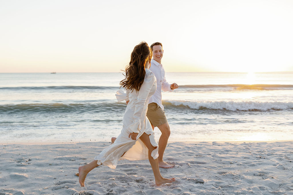 Bride-to-be in flowy beach engagement photo dresses at golden hour in Naples Florida