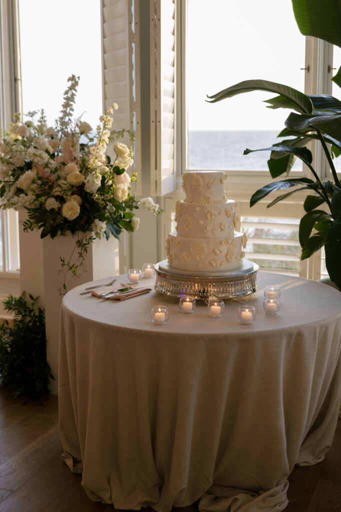White wedding cake decorated with florals at Ritz Carlton Naples Florida wedding by Veronica Costa Photography