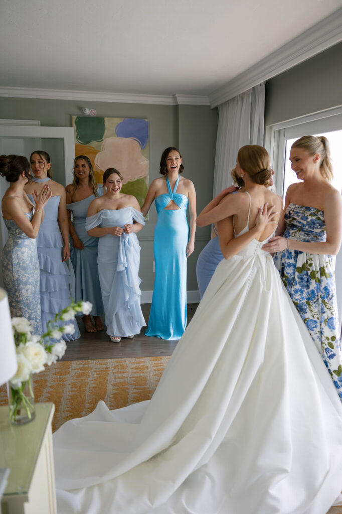 Bridesmaids looking at bride in the terrace suite at LaPlaya wedding in Naples by Veronica Costa Photography