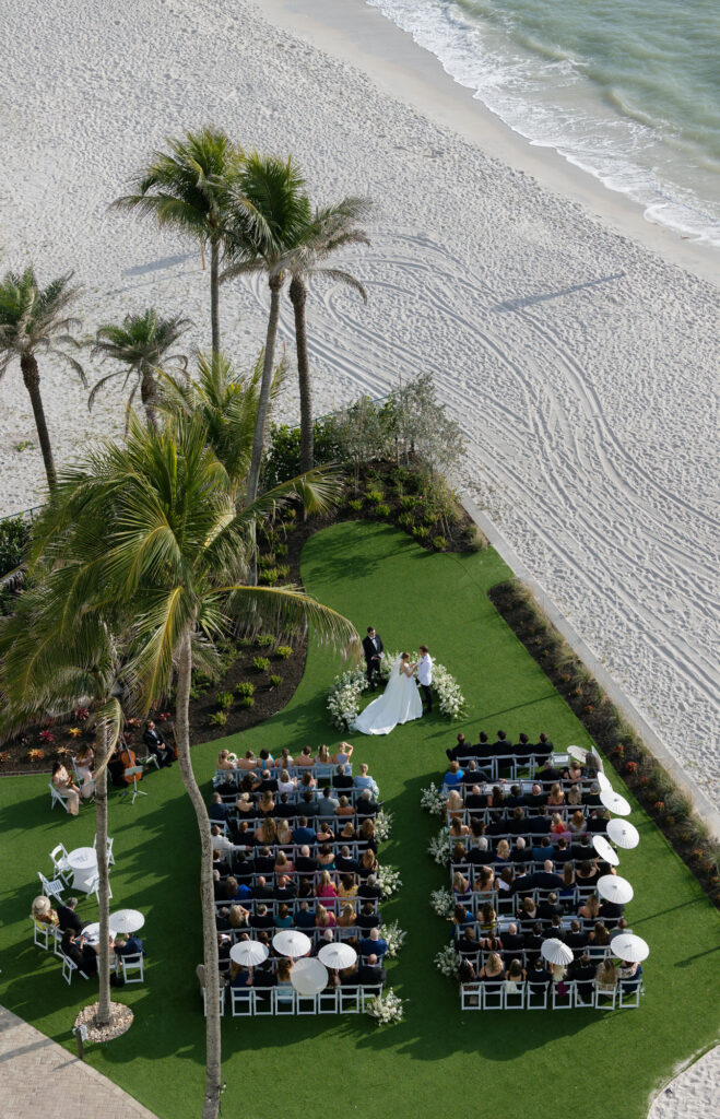 drone shot of ceremony on Green Lawn at LaPlaya beach resort wedding
