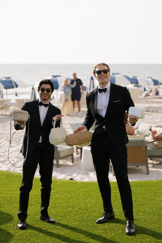 Groomsmen holding purses before wedding ceremony