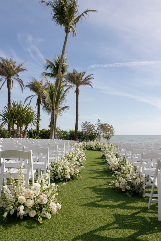 Naples LaPlaya Beach Resort Gulf Lawn ceremony setup with floral arch by Veronica Costa Photography