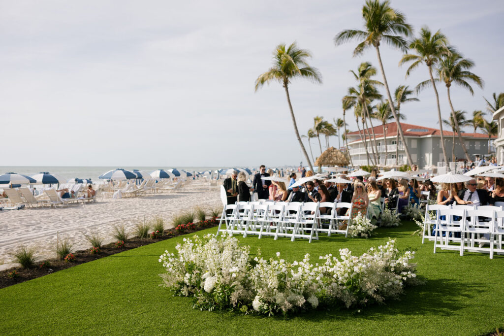 Aisle lined with chairs and petals at LaPlaya Beach Resort in Naples ceremony by Veronica Costa Photography
