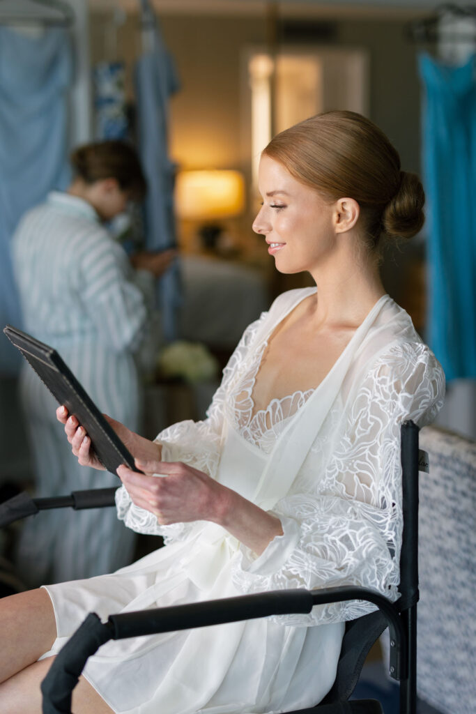 Bride getting ready at LaPlaya Naples wedding with hair and makeup on the terrace by Veronica Costa Photography