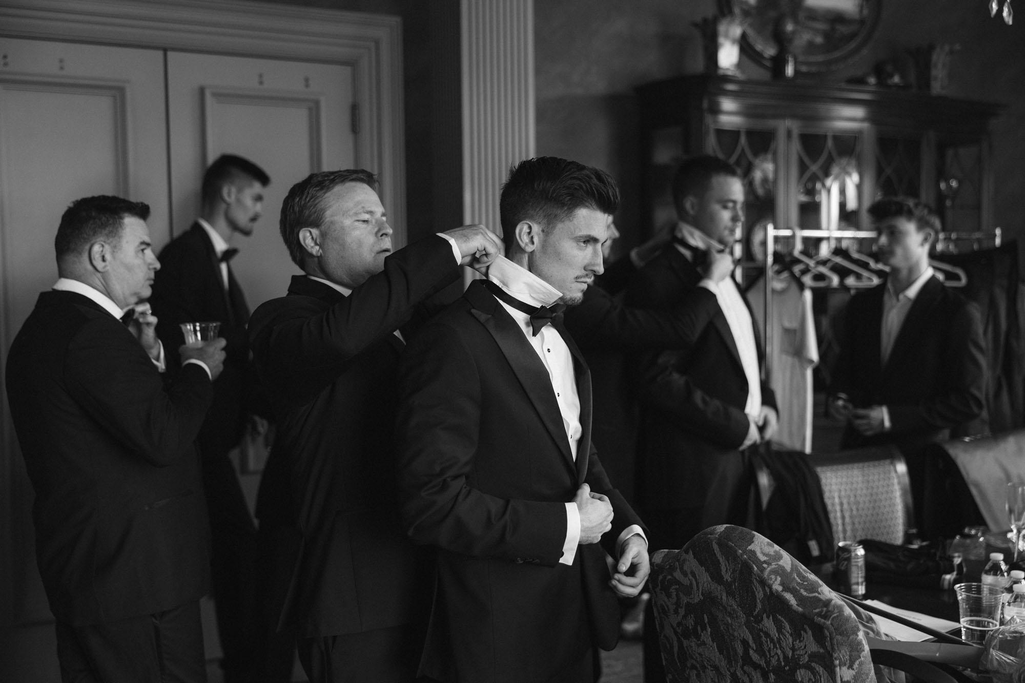 Groom with groomsmen getting ready in suite before The Club at the Strand wedding by Veronica Costa Photography
