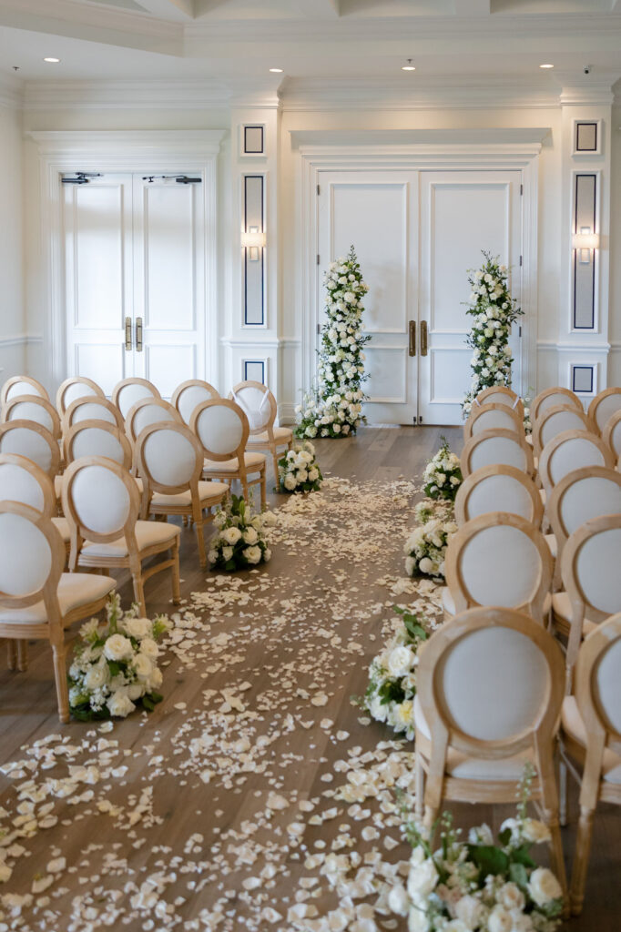 ceremony setup with floral arch for The Club at the Strand wedding by Veronica Costa Photography