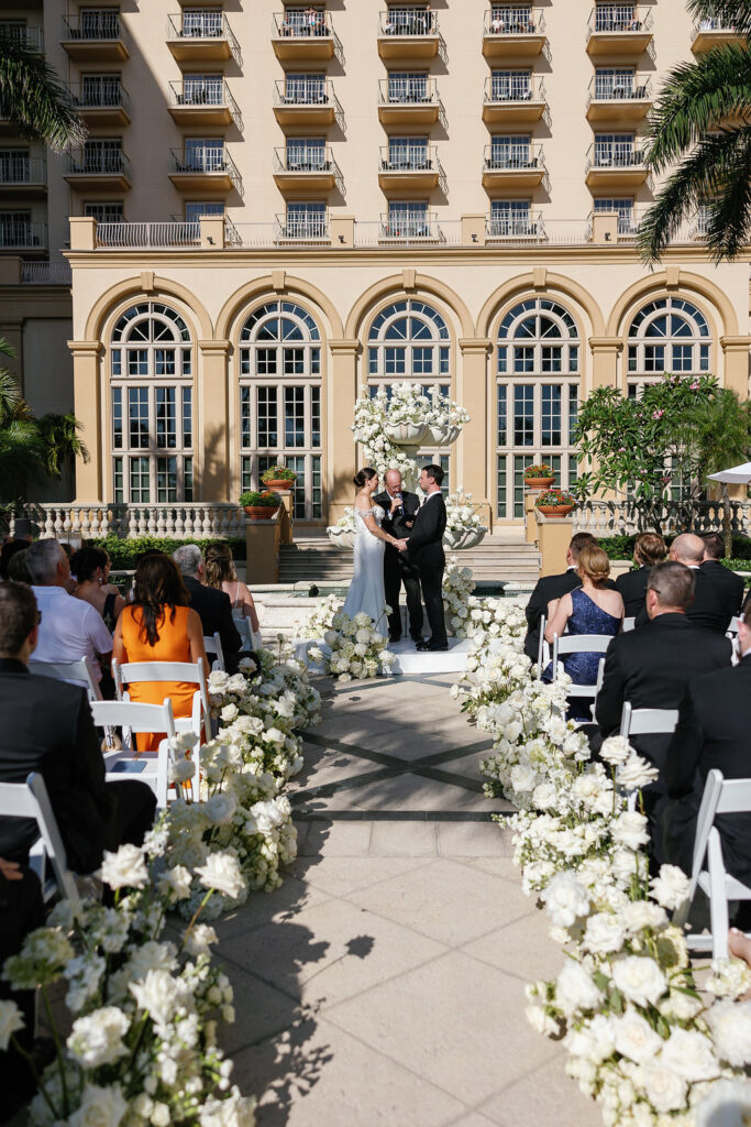 Wedding ceremony captured at one of the most iconic wedding venues in Naples FL, The Ritz-Carlton, Naples Beach Resort. 